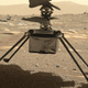 Dangling inches above the Martian surface, Ingenuity’s four legs can be seen fully outstretched. Perseverance captured this image with its WATSON camera on March 30.